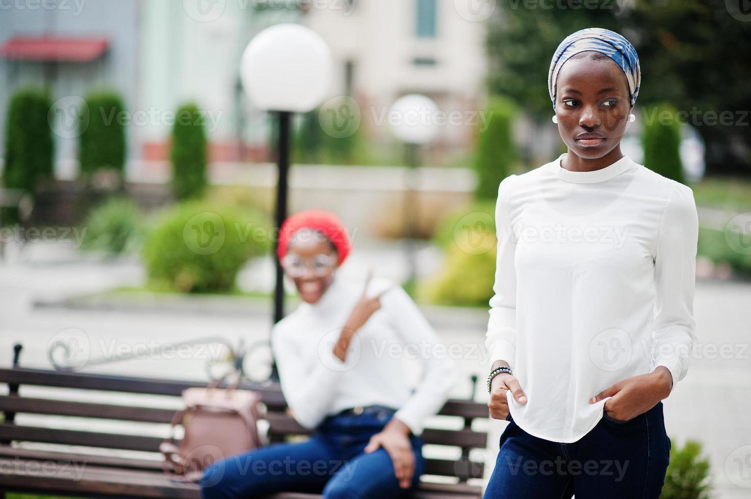 Two young modern fashionable, attractive, tall and slim african muslim womans in hijab or turban head scarf posed together. photo