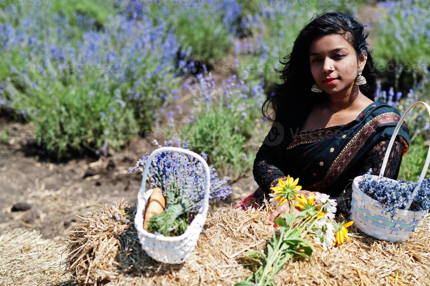 Beautiful indian girl wear saree india traditional dress in purple lavender field. photo