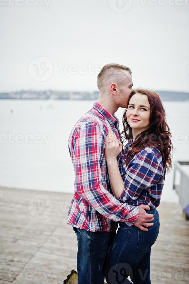 Stylish couple wear on checkered shirt in love together. photo