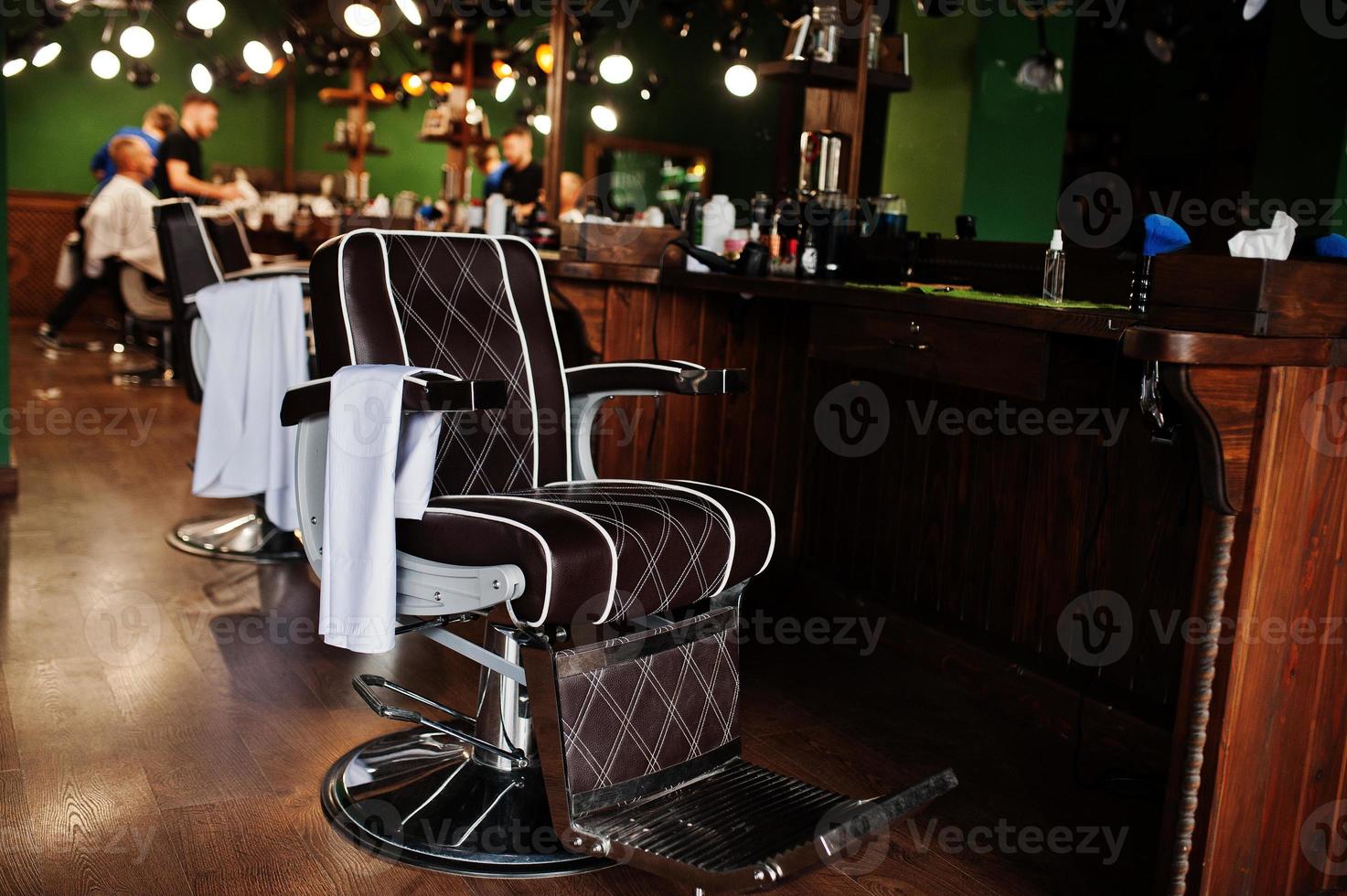 Brown vintage leather chairs at stylish barber shop. photo