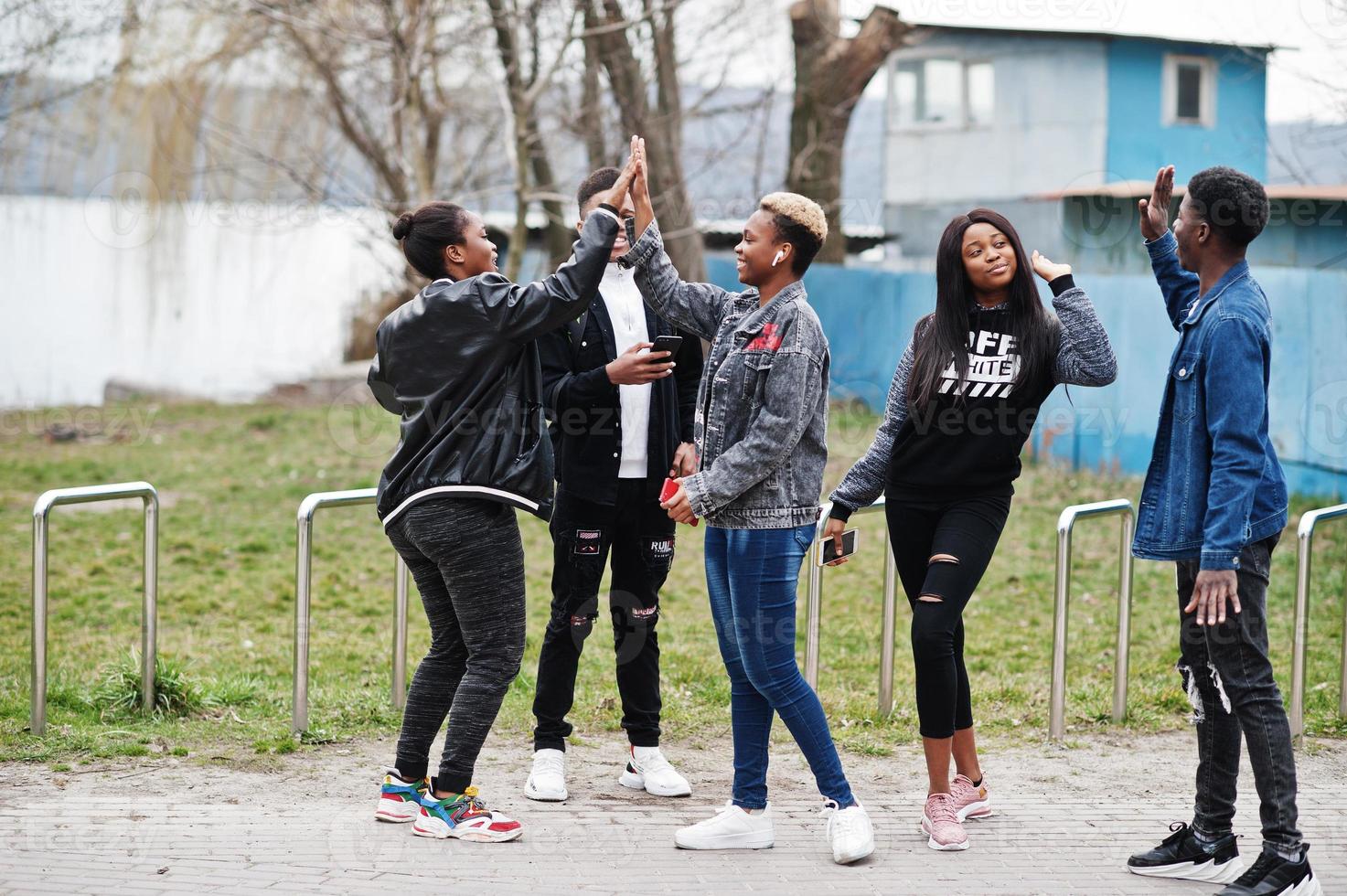 Young millennials african friends walking in city. Happy black people having fun together. Generation Z friendship concept. photo