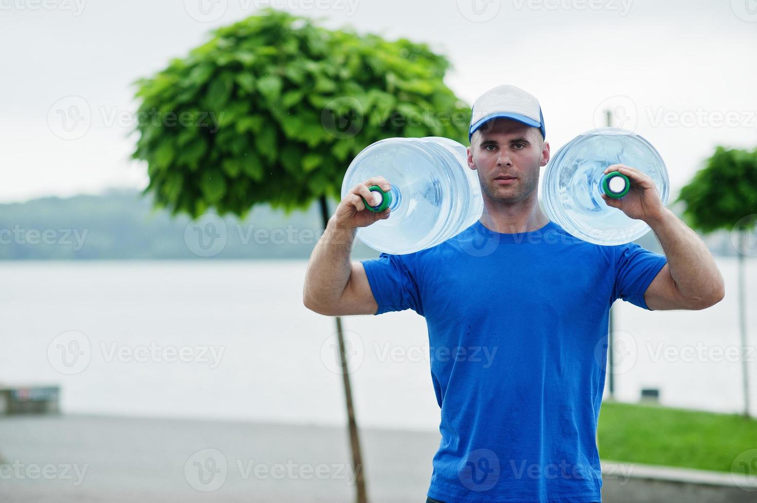 Delivery man carrying water bottle on shoulder. photo