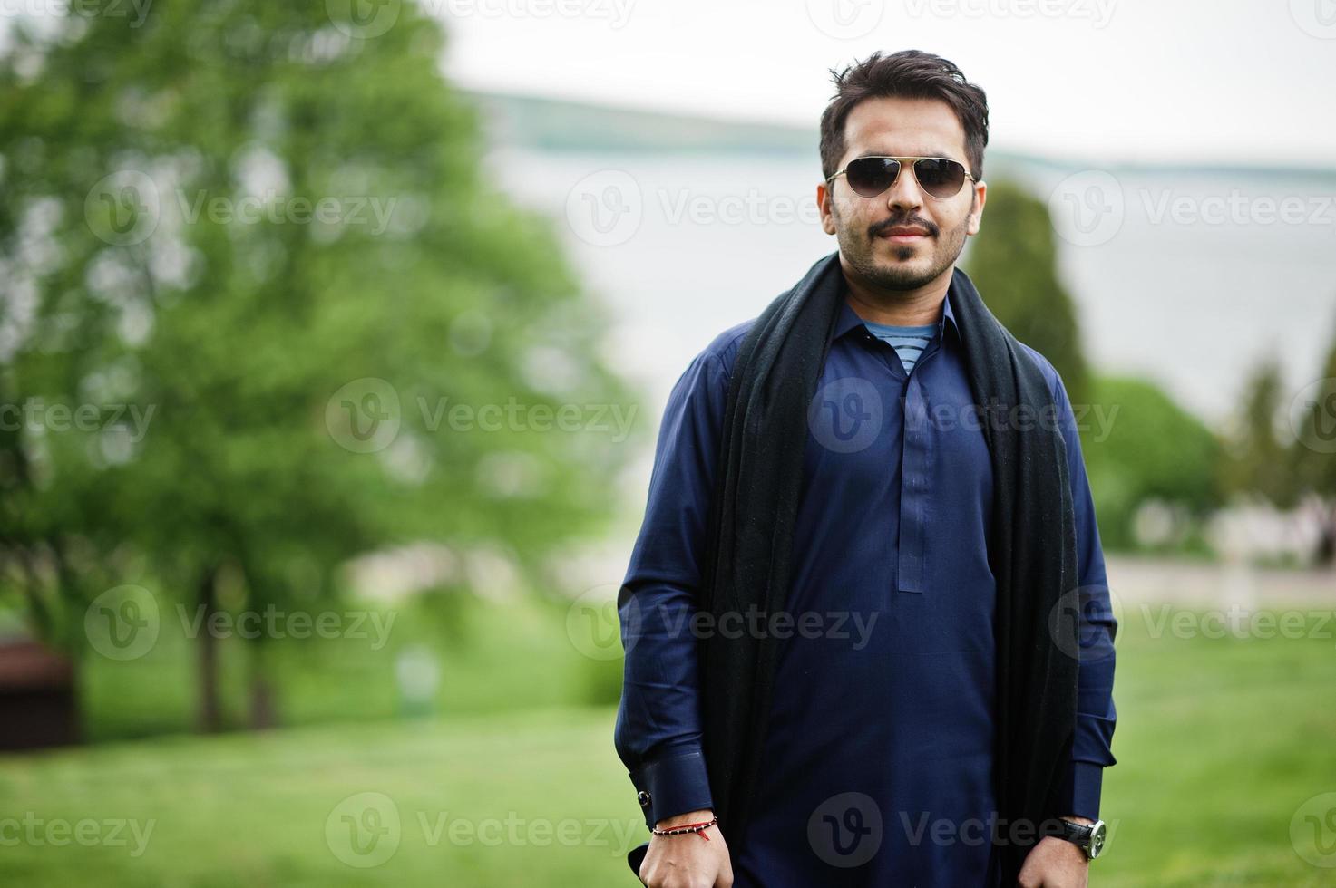 Stylish pakistani indian muslim arabic man in kurta dhoti suit and sunglasses. photo