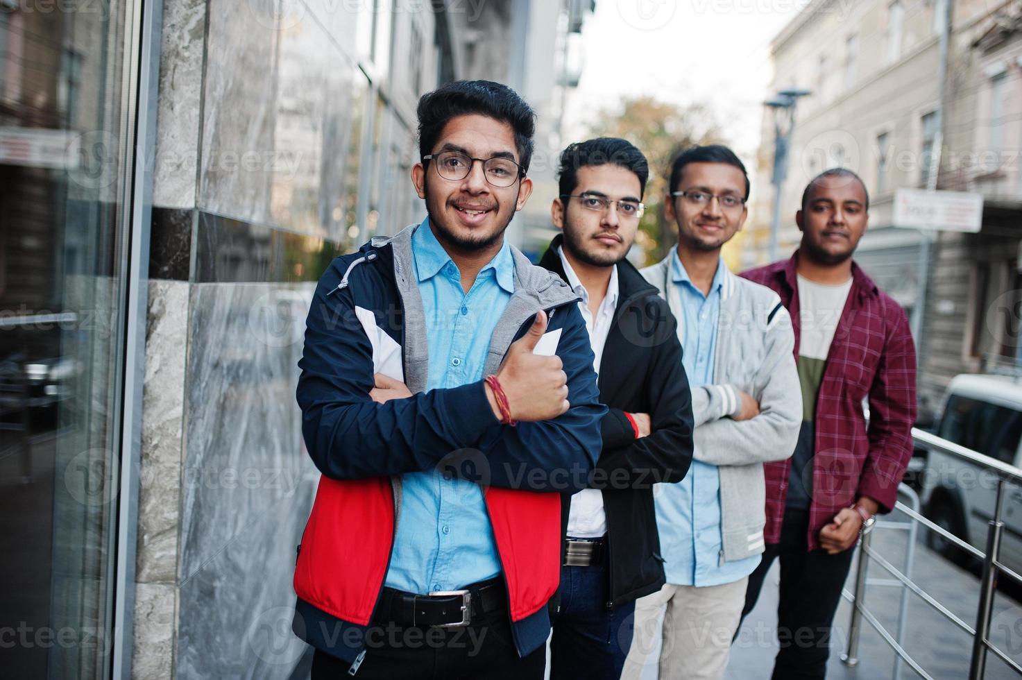 Group of four indian teen male students. Classmates spend time together. photo