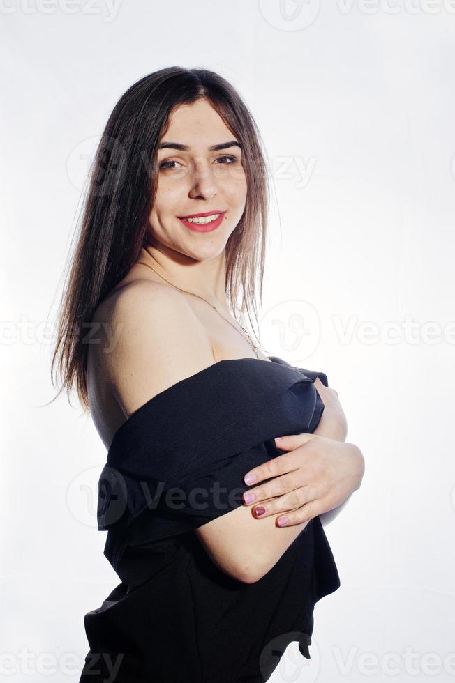 Close-up emotional portrait of a brunette girl in black jumpsuit on white background. photo