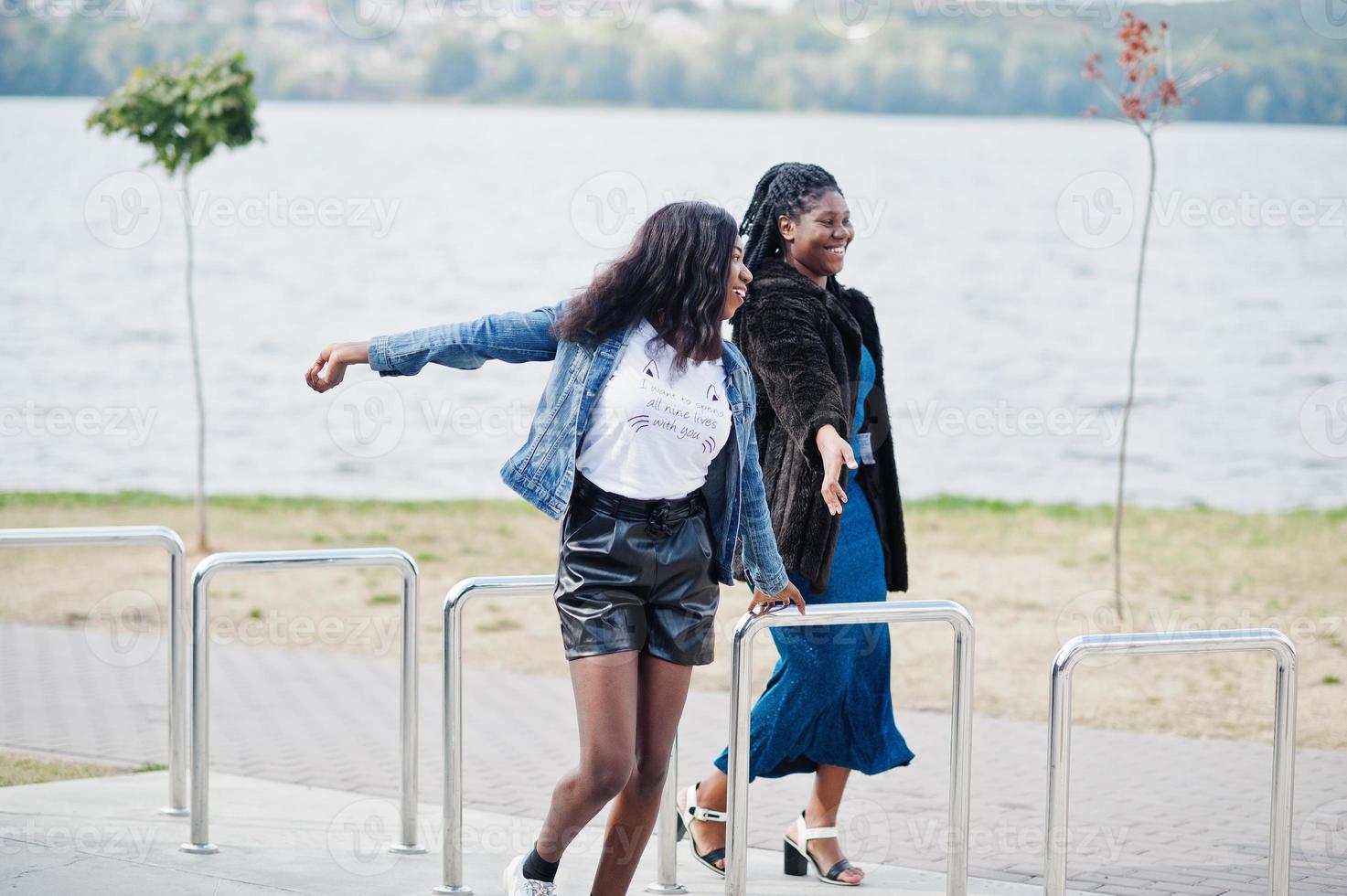 Two african american dark skinned friends female. One of them plus size model, second slim. Having fun and spending time together. photo