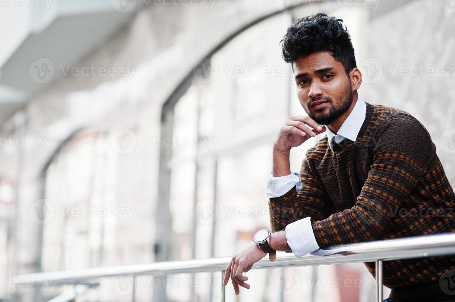 Portrait of young stylish indian man model pose in street. photo