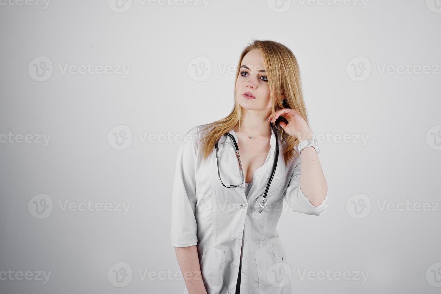 Blonde sexy doctor nurse with stethoscope isolated on white background. photo