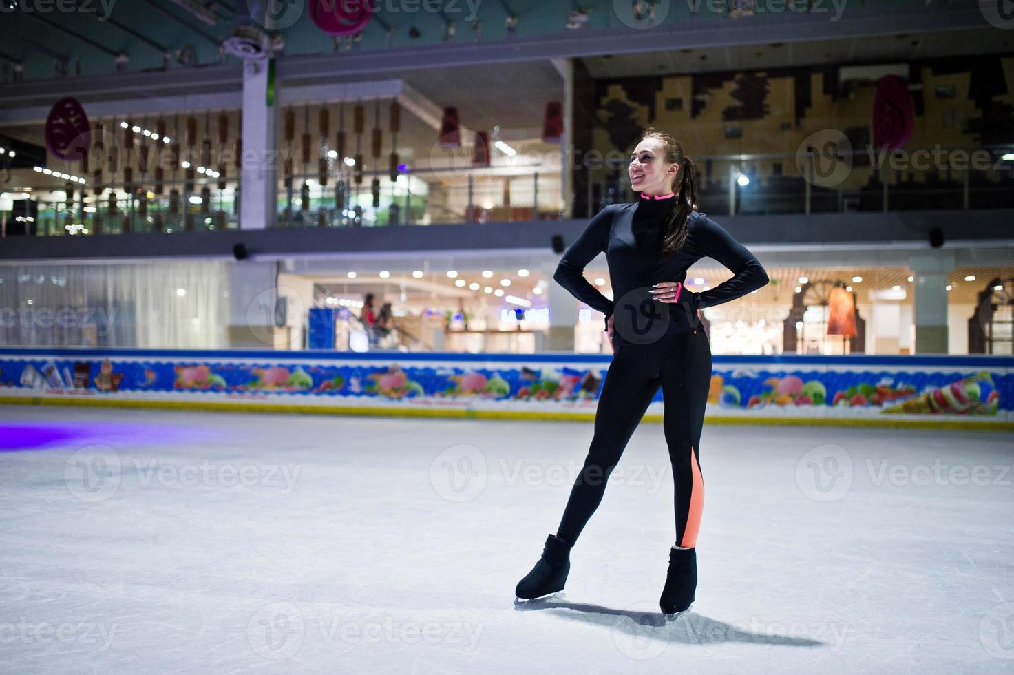 Figure skater woman at ice skating rink. photo