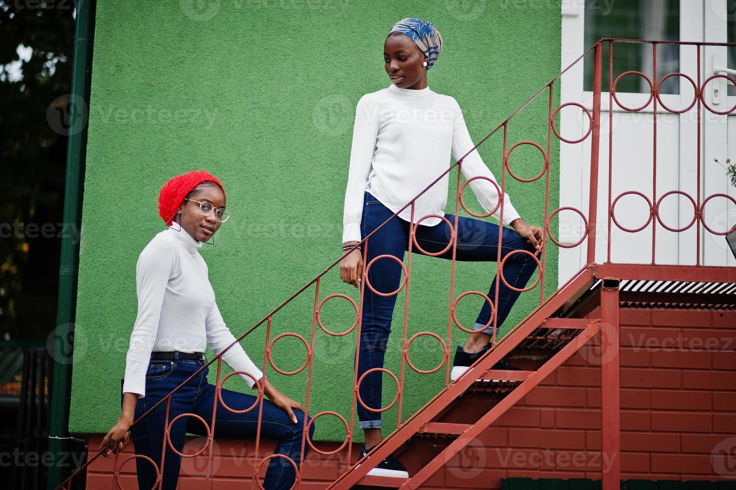 Two young modern fashionable, attractive, tall and slim african muslim womans in hijab or turban head scarf posed together. photo