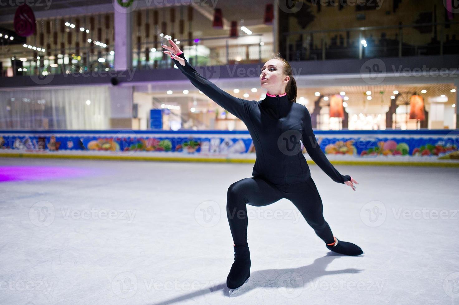 Figure skater woman at ice skating rink. photo