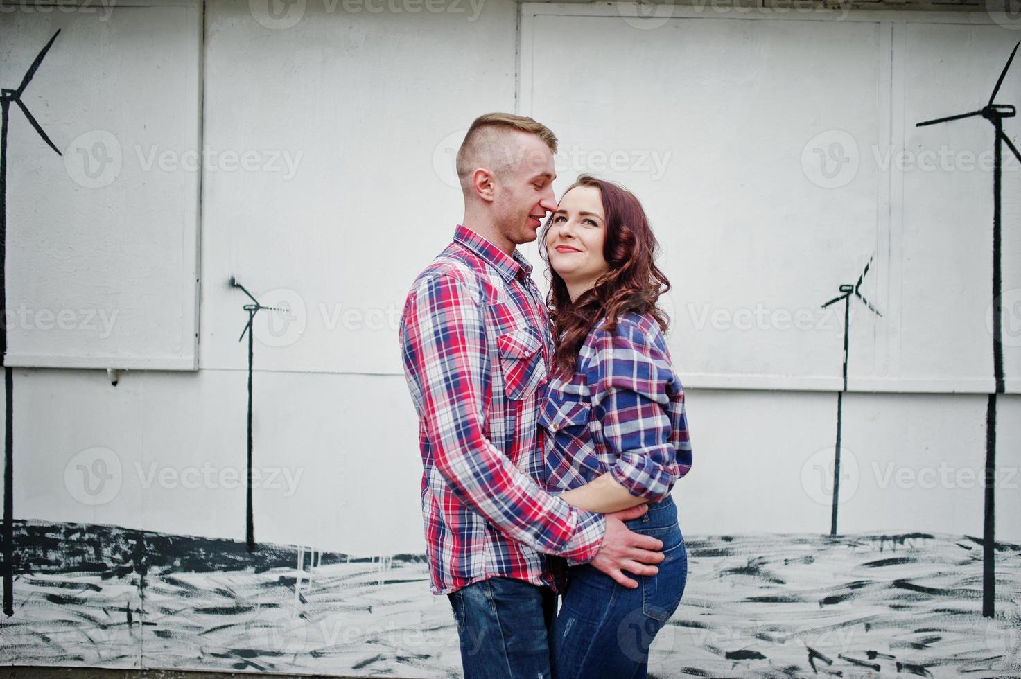 Stylish couple wear on checkered shirt in love together. photo