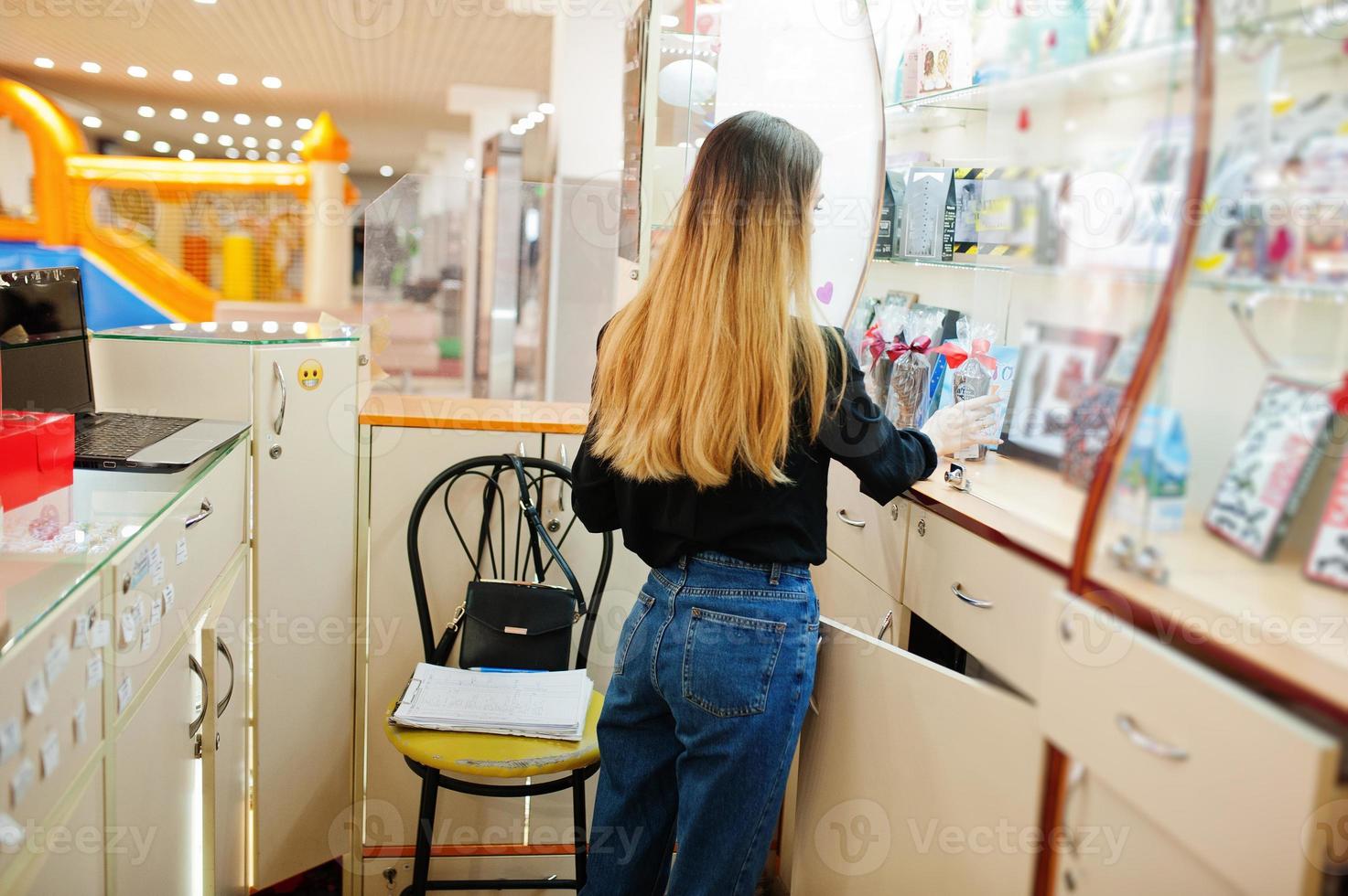 Portrait of young caucasian female woman seller. Small business of candy souvenirs shop. photo