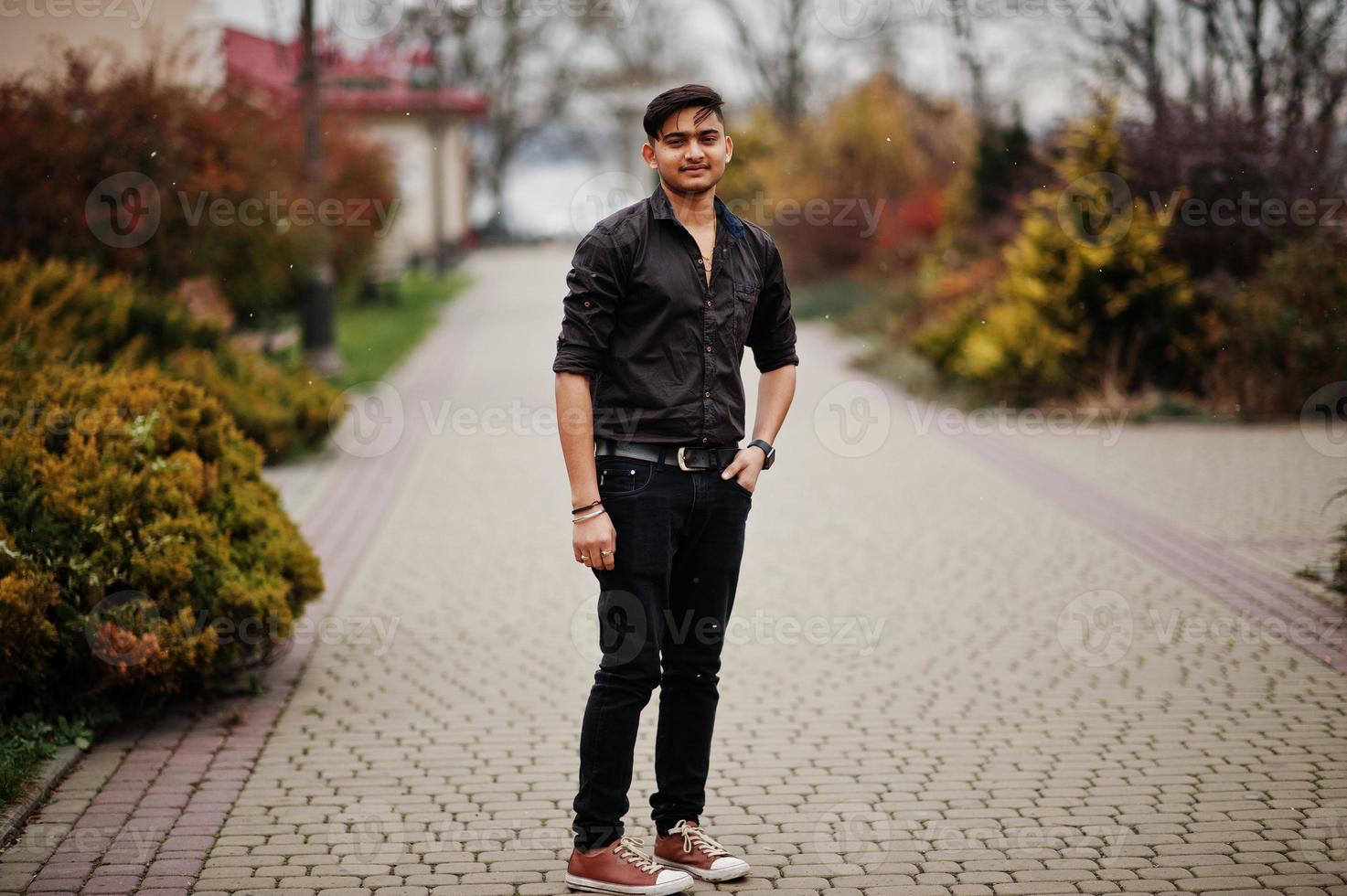 Indian man in brown shirt posed outdoor. photo