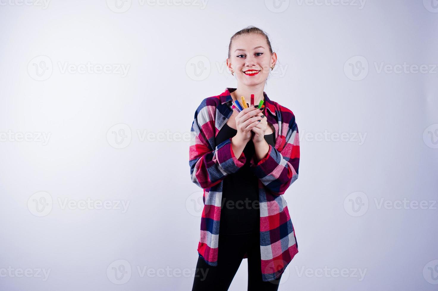 Beautiful woman artist painter with brushes posing in studio isolated on white. photo