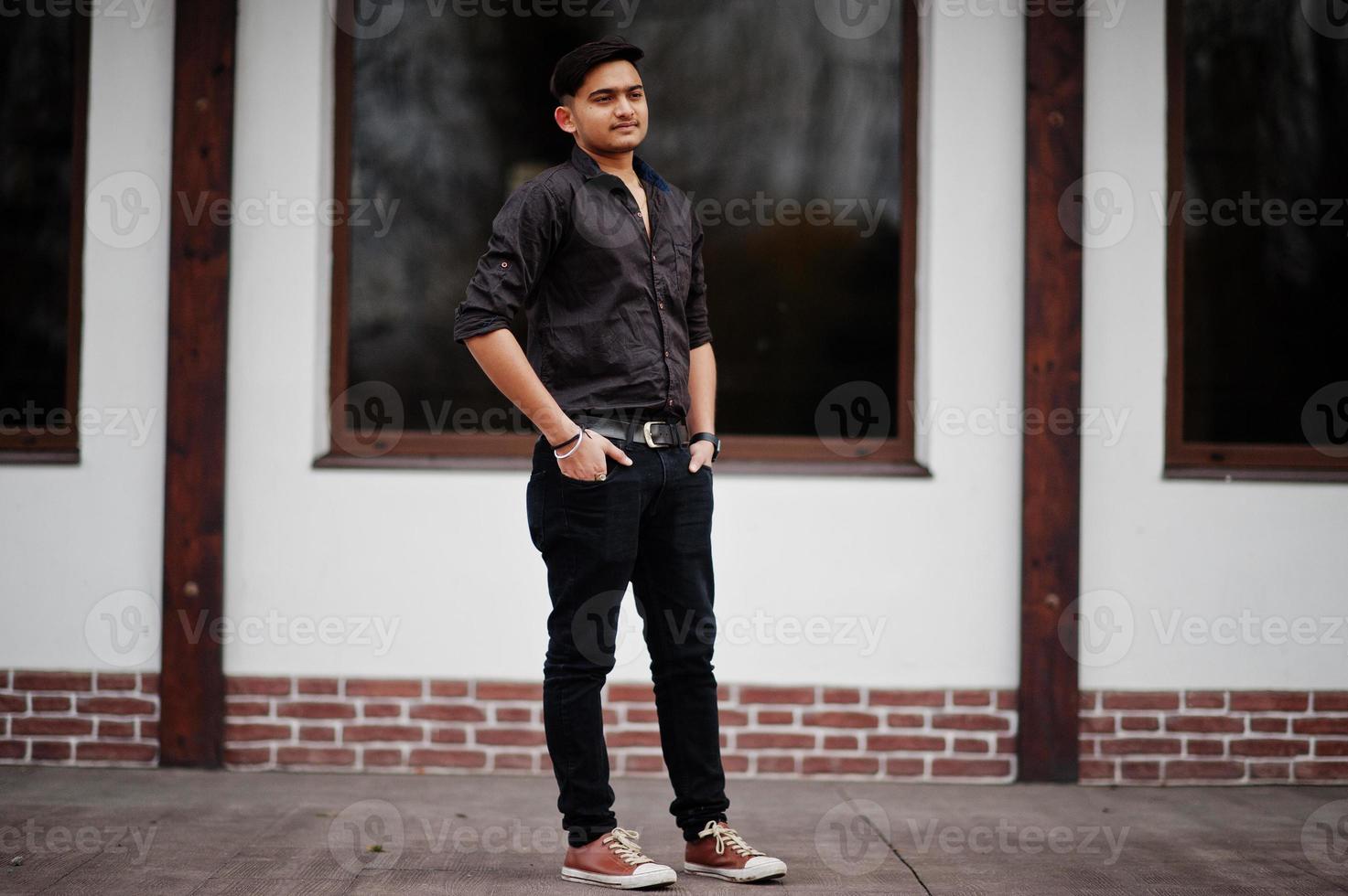 Indian man in brown shirt posed outdoor. photo