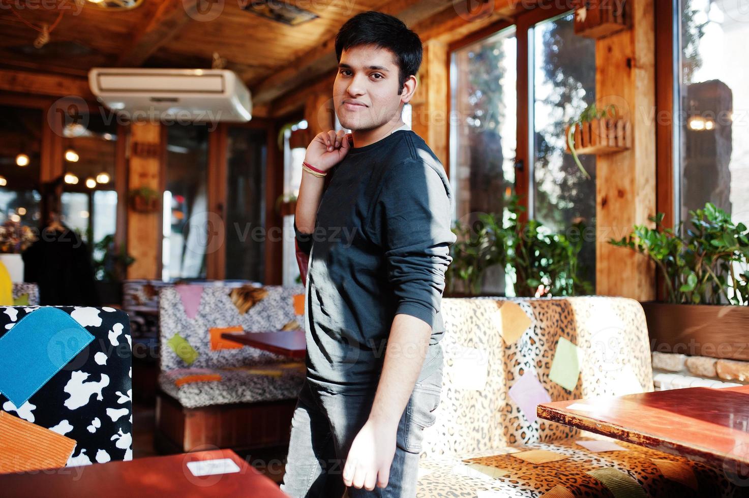 Stylish indian man in casual wear posing indoor cafe. photo