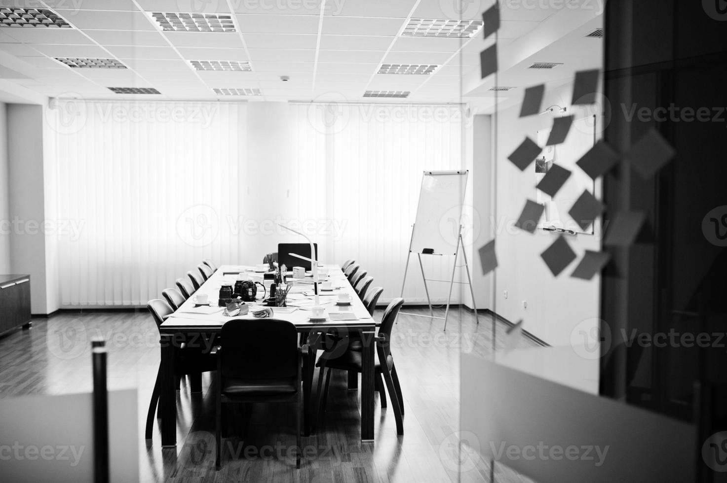 Modern business office interior containing tables and chairs, laptop, camera and office supplies with no employees. photo