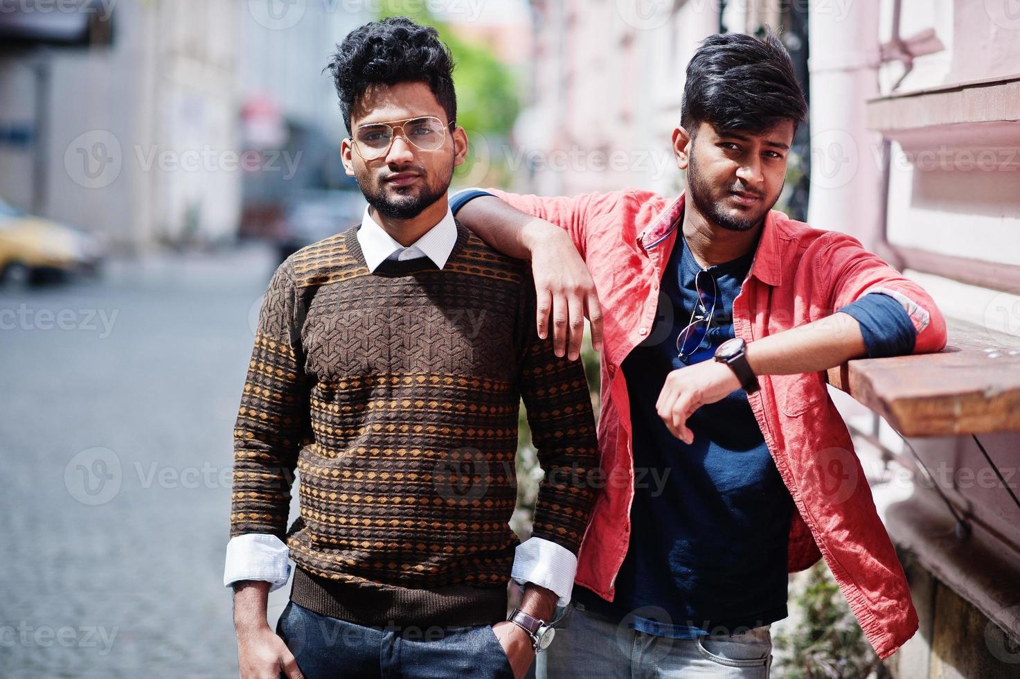 Two young stylish indian man frieds model posing in street. photo