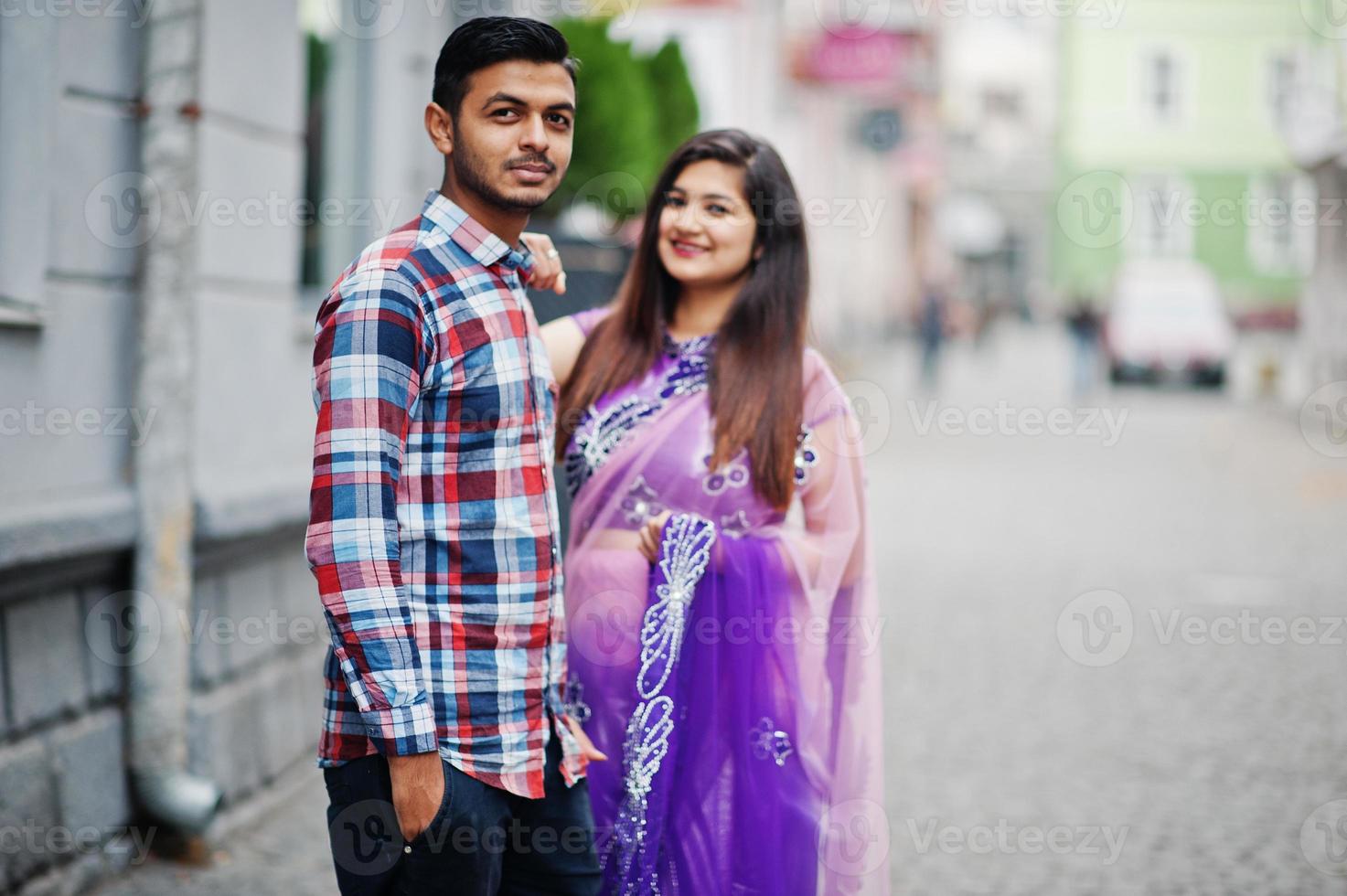 Stylish indian hindu couple posed on street. photo