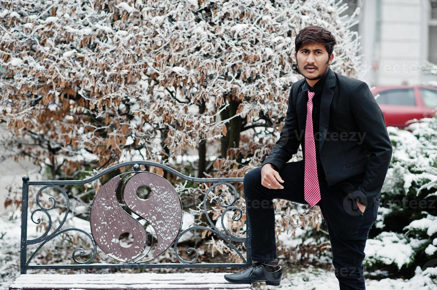 Young indian man on suit and tie posed outdoor in winter day. photo