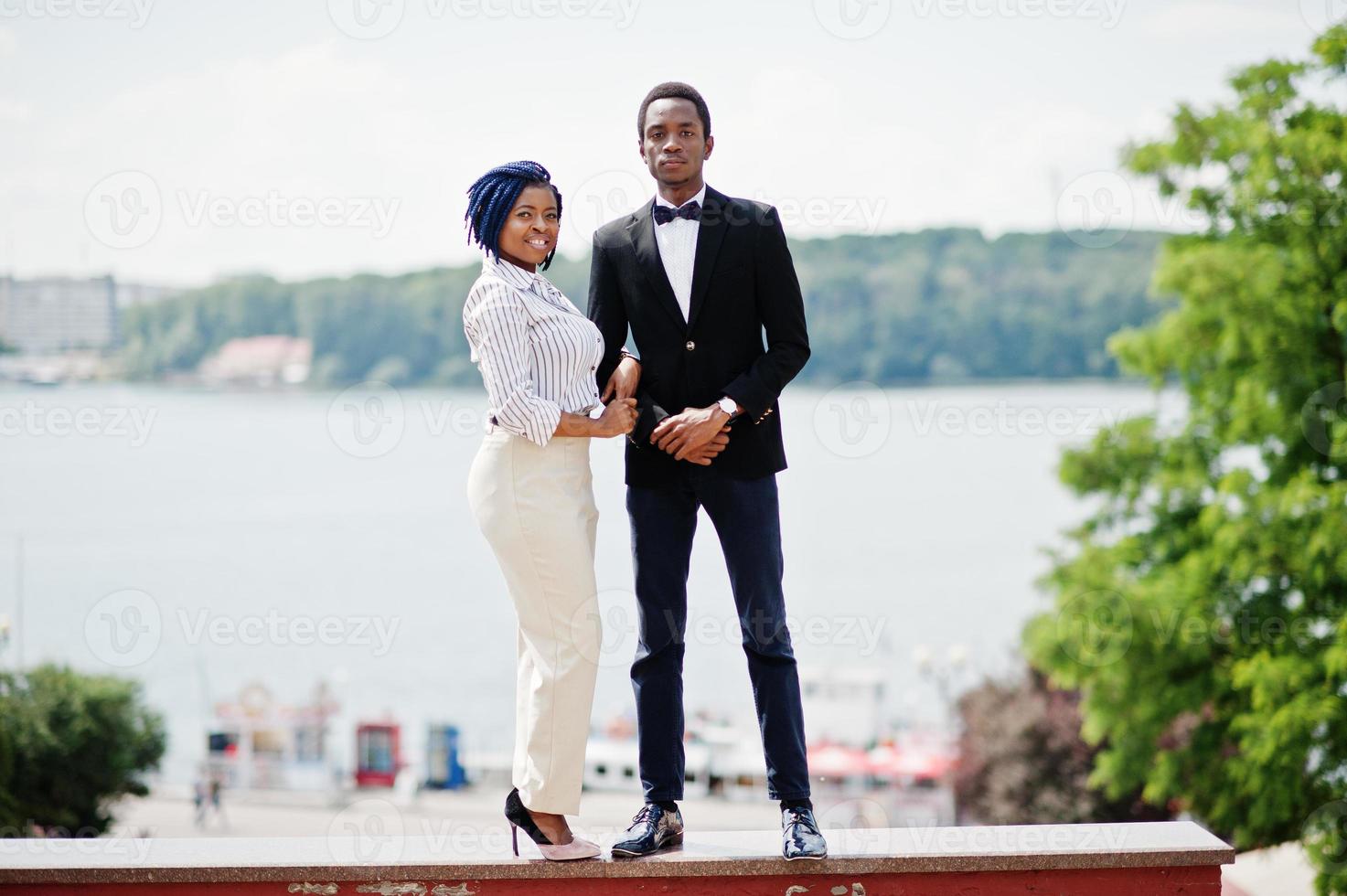 Group of two african american stylish couple posed at street of city. photo