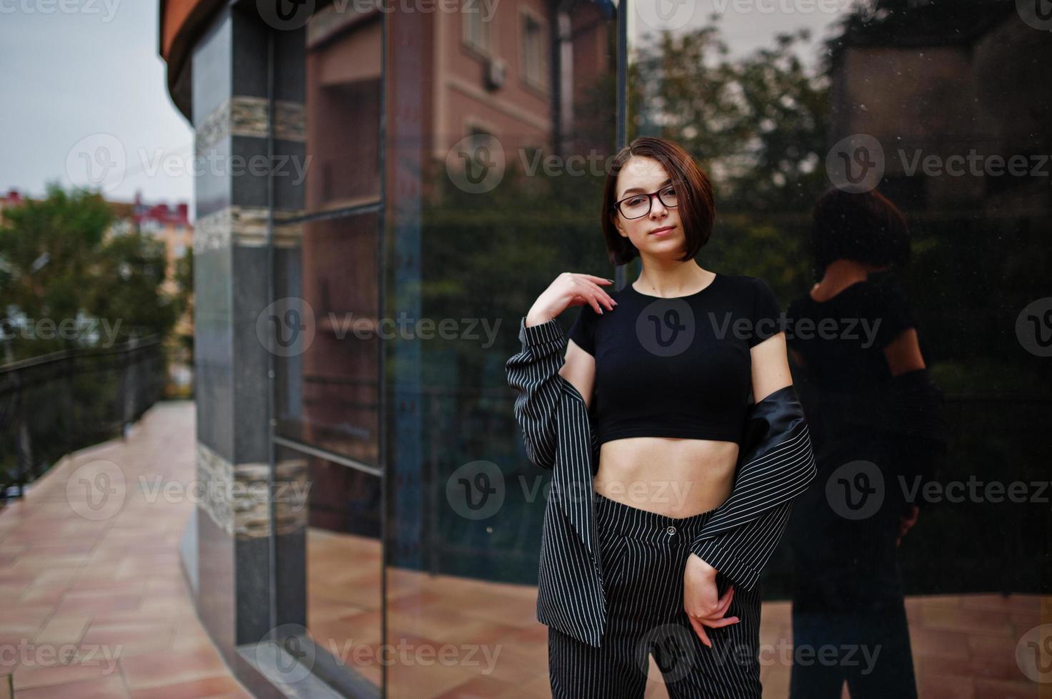 A tall leggy young beautiful and elegant model woman. Business woman at eyeglasses. photo