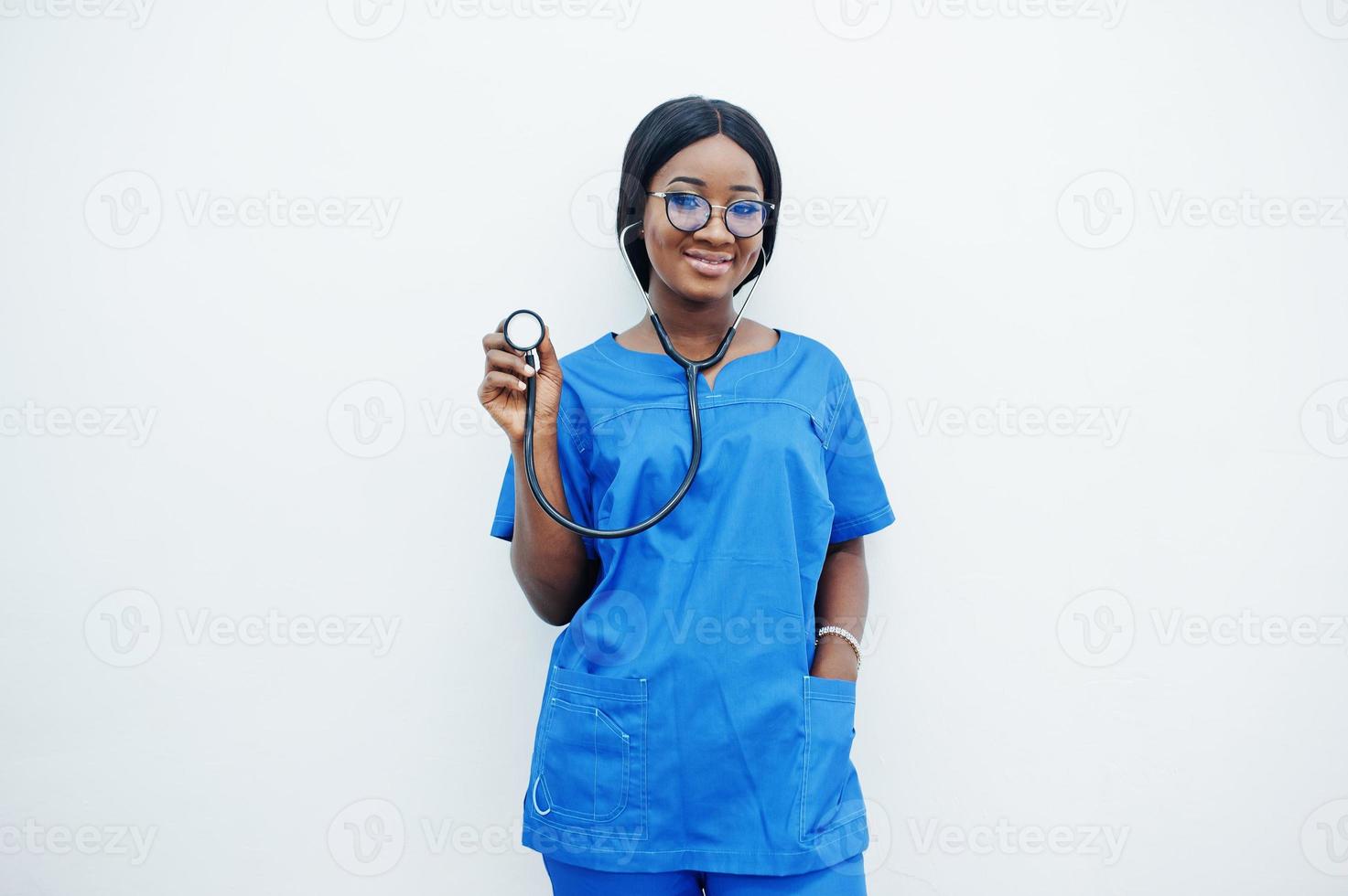 Portrait of happy female african american young doctor pediatrician in blue uniform coat and stethoscope isolated on white. Healthcare, medical, medicine specialist - concept. photo