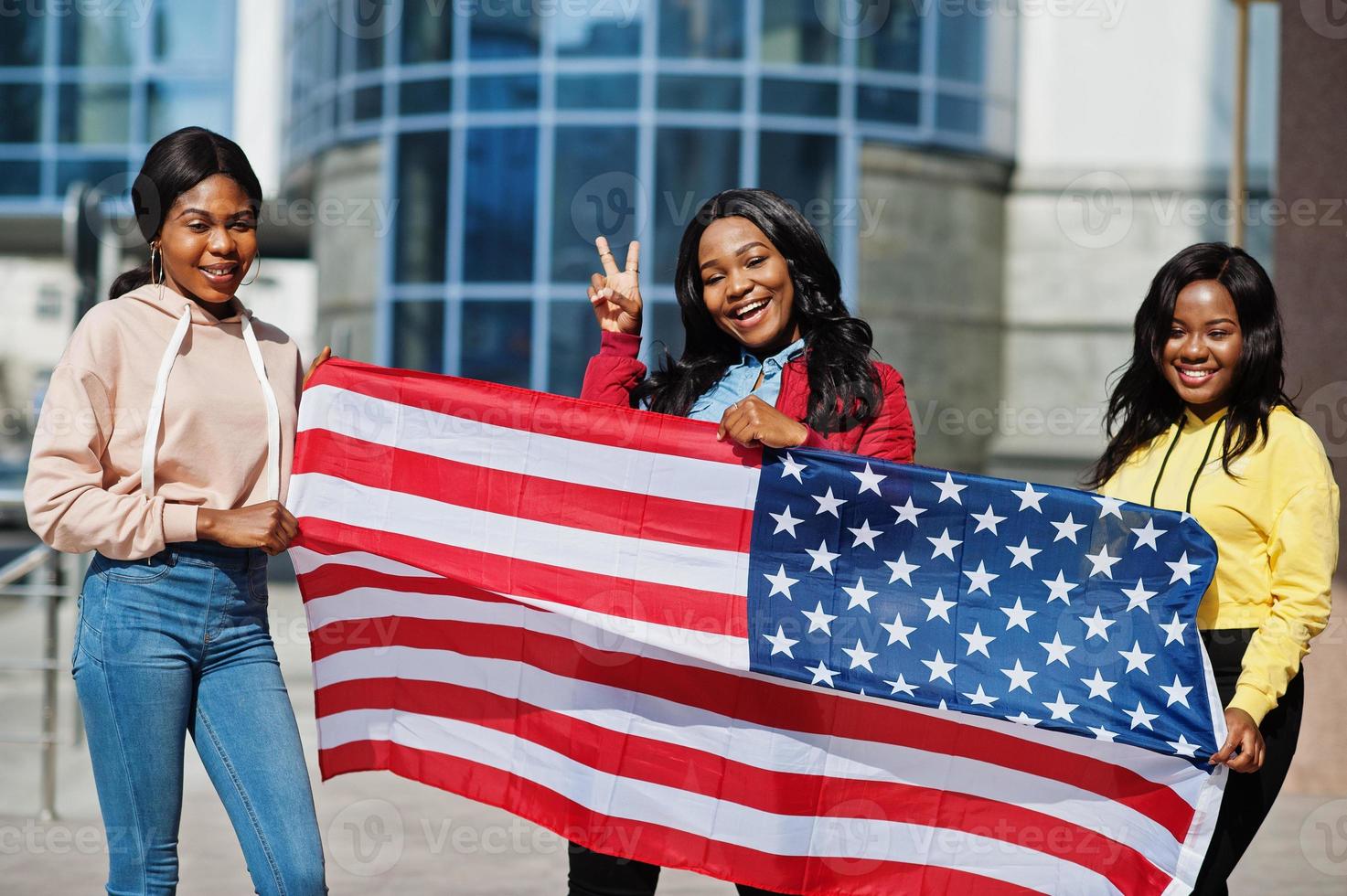 Three young college african american womans friends with flag of USA. photo