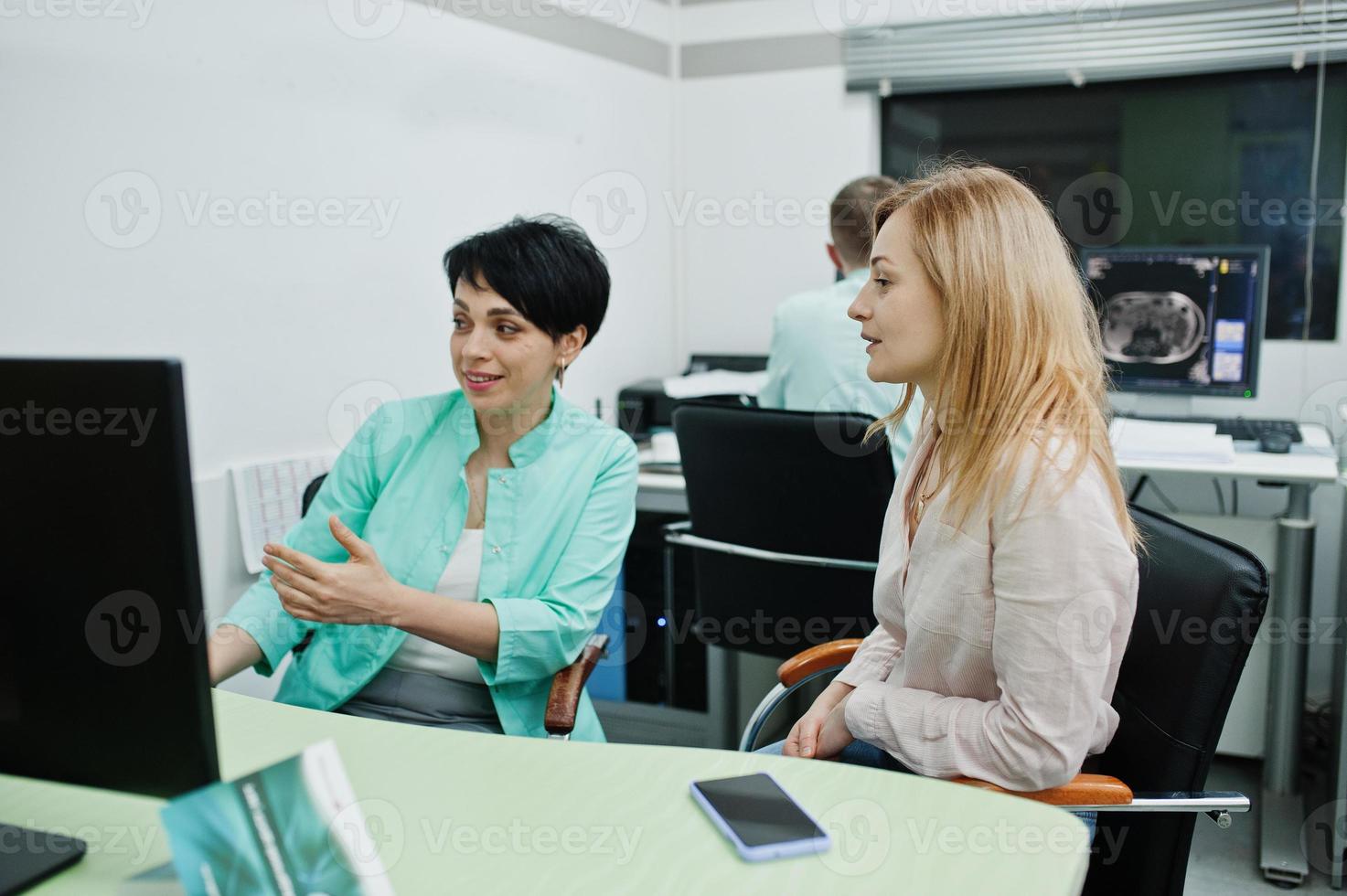Medical theme. Observation room with a computer tomograph. Doctor advises the patient in the mri office at diagnostic center in hospital. photo