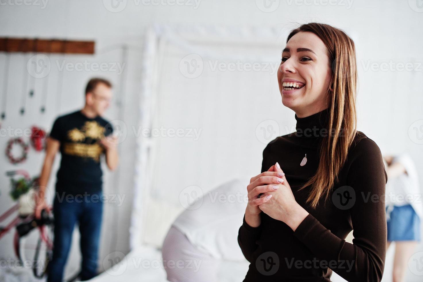Girl laughing against  photographer in work at studio. photo