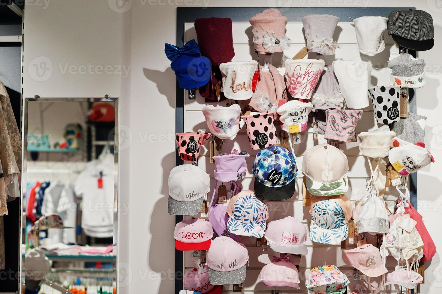 Luxury and fashionable brand new interior of kids  hats and caps cloth store. photo