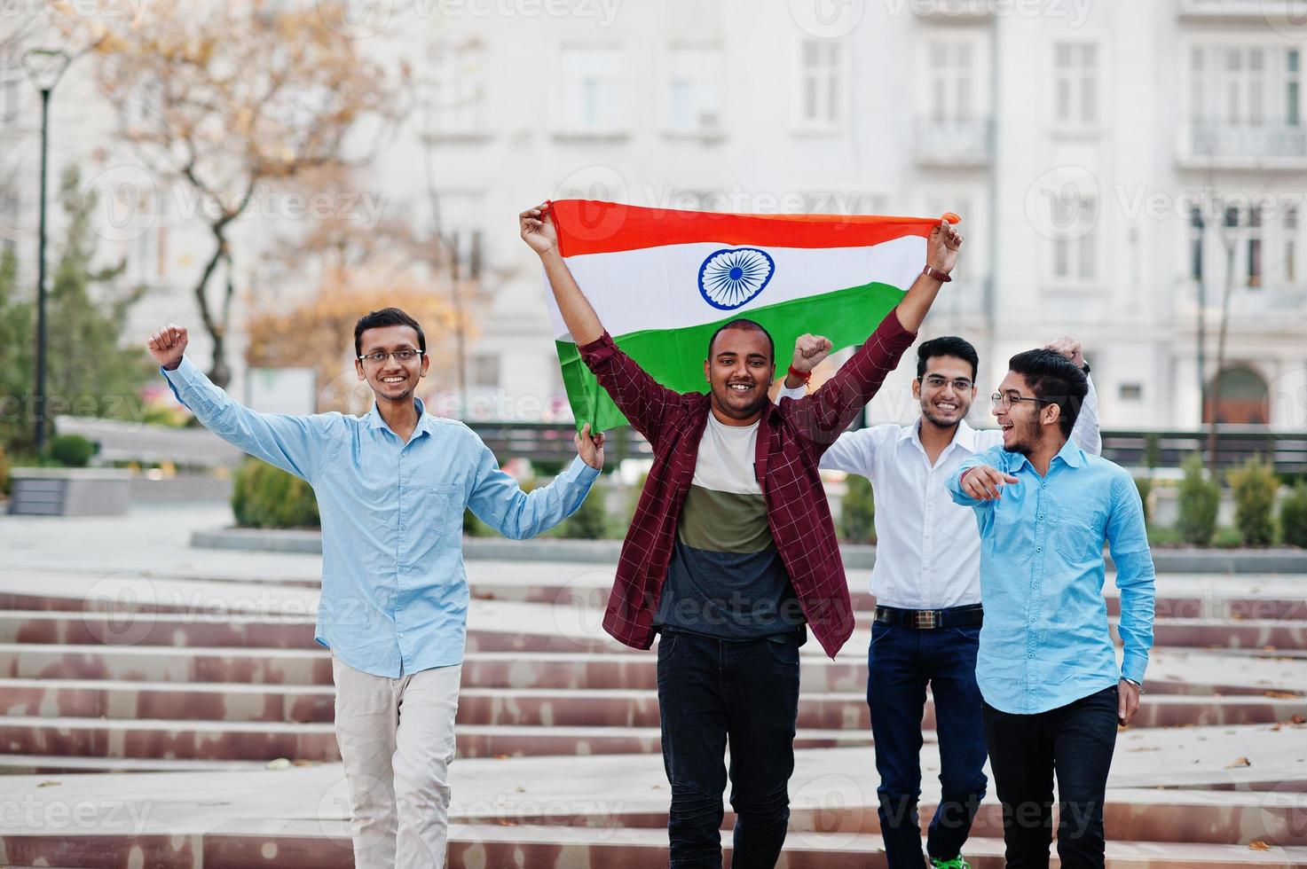 Group of four south asian indian male with India flag. photo