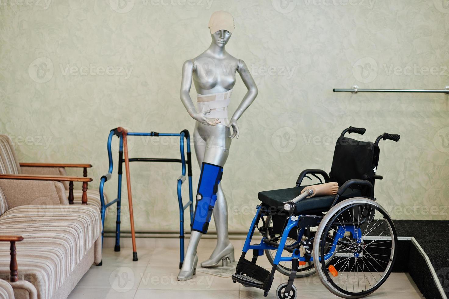 Wheelchair and mannequin at prosthetist clinic. photo
