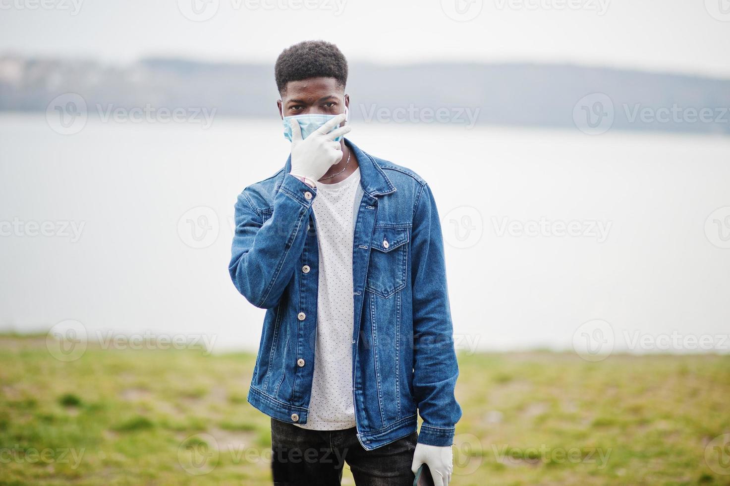 African man at park wearing medical masks protect from infections and diseases coronavirus virus quarantine. photo