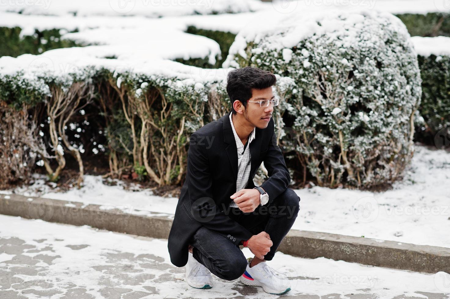 Young indian man on suit posed outdoor in winter day. photo