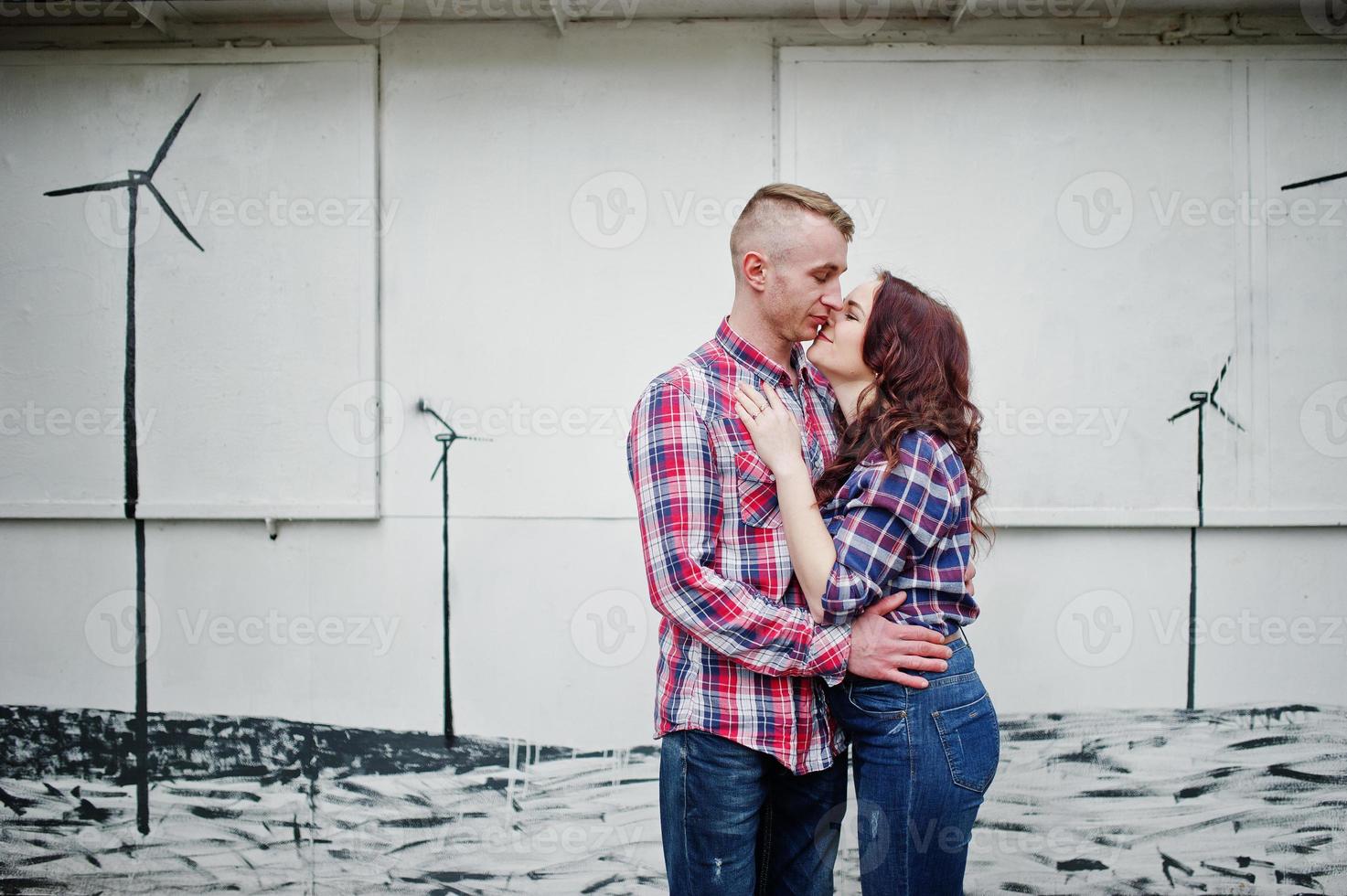 Stylish couple wear on checkered shirt in love together. photo