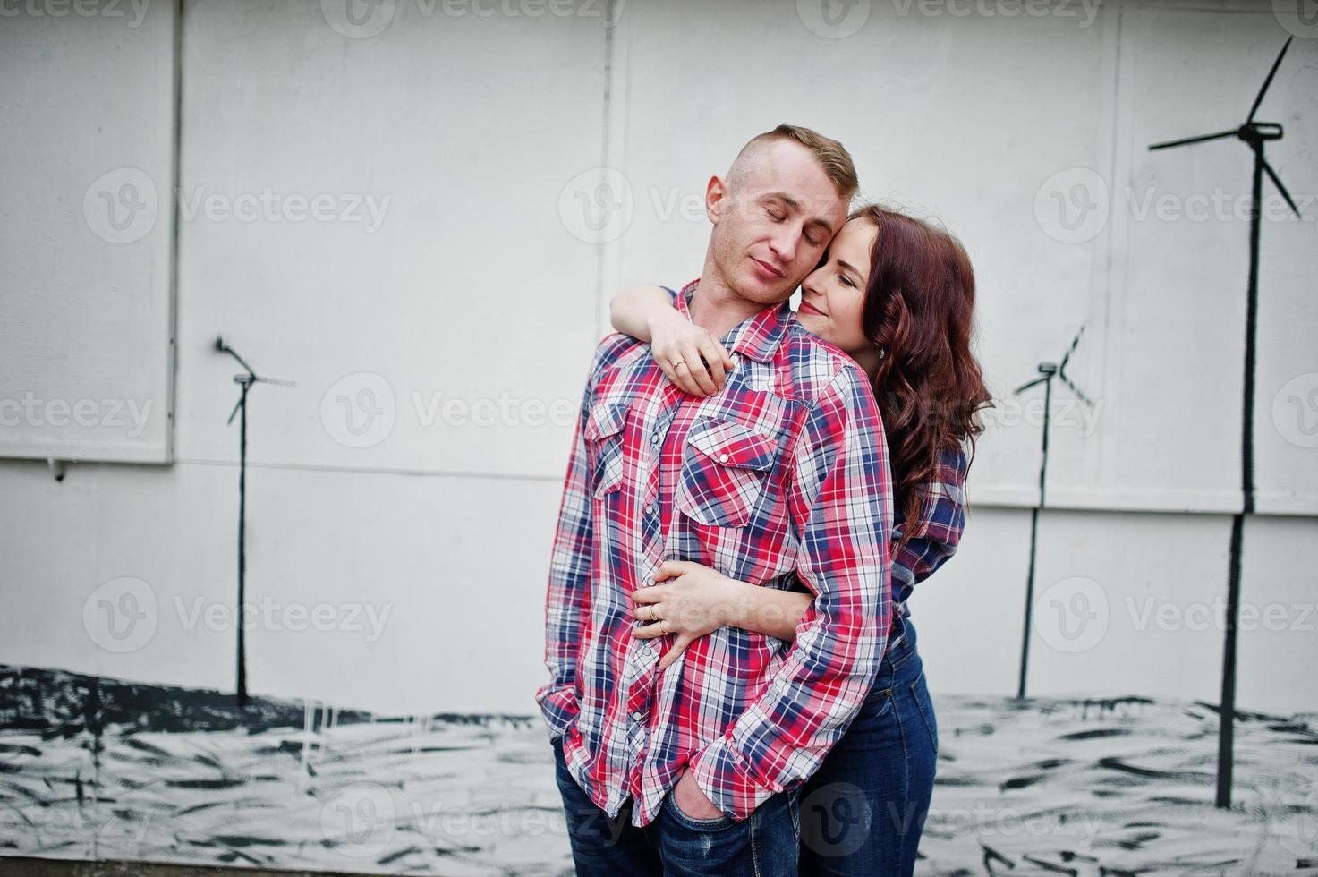 Stylish couple wear on checkered shirt in love together. photo