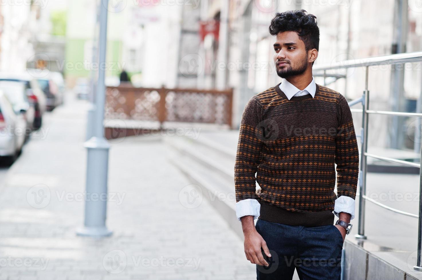 Portrait of young stylish indian man model pose in street. photo