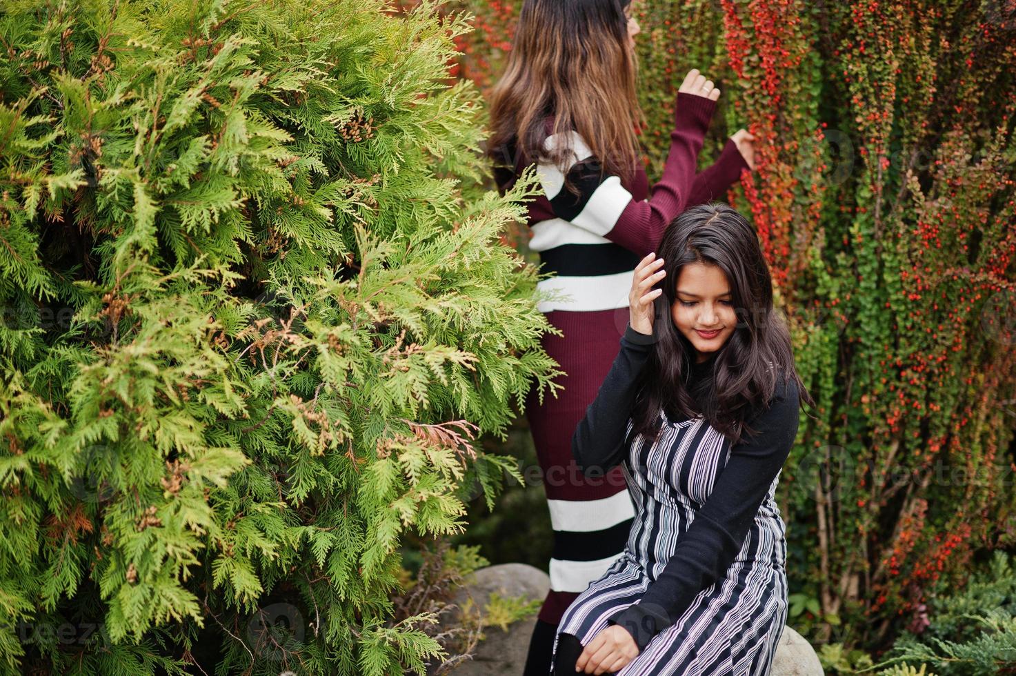 Portrait of two young beautiful indian or south asian teenage girls in dress. photo