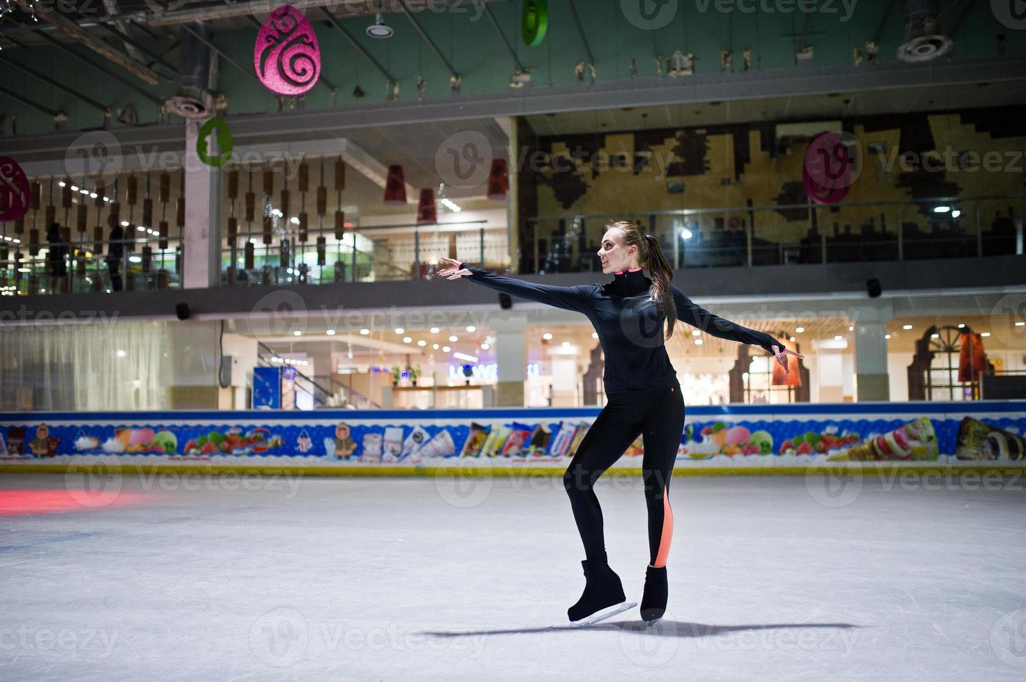 Figure skater woman at ice skating rink. photo