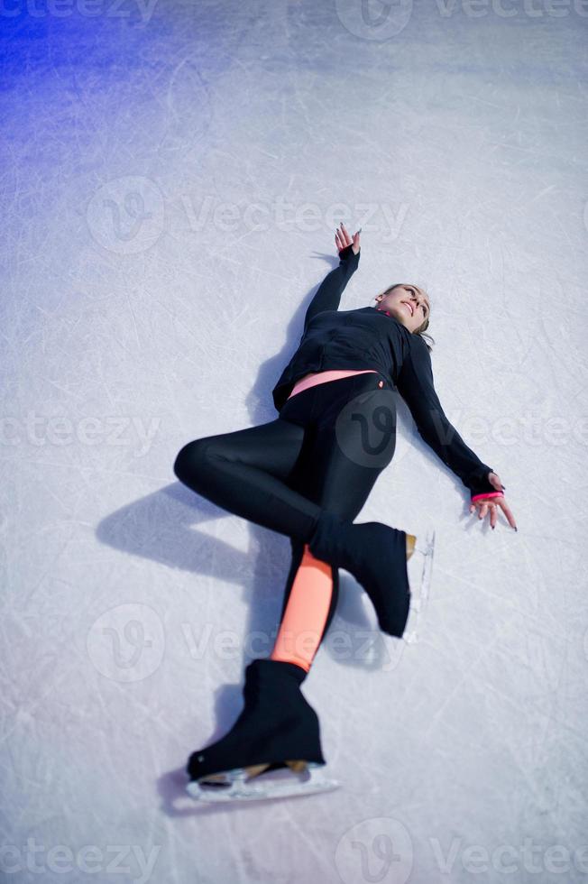 Figure skater woman at ice skating rink. photo