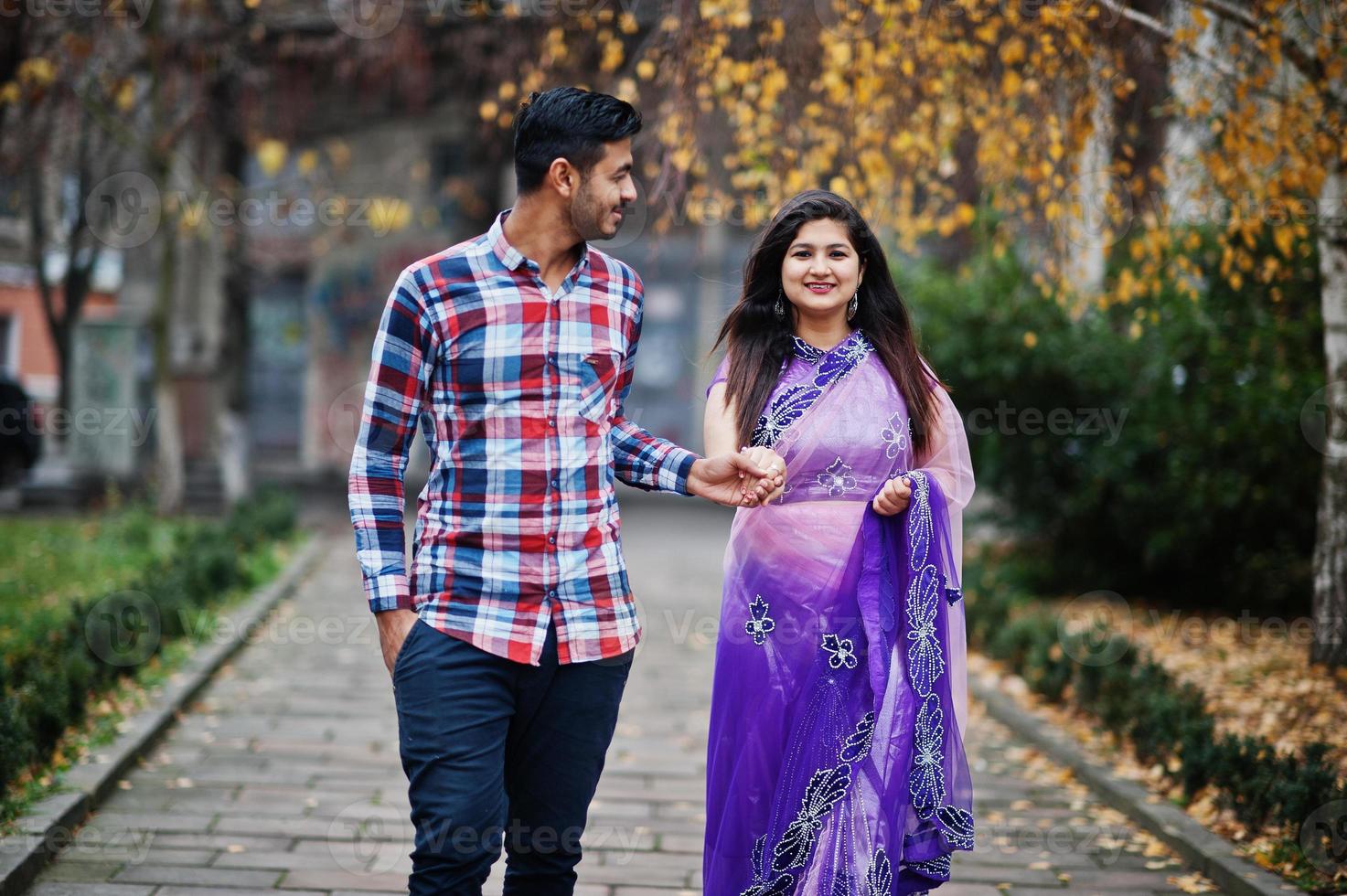 Stylish indian hindu couple posed on street. photo