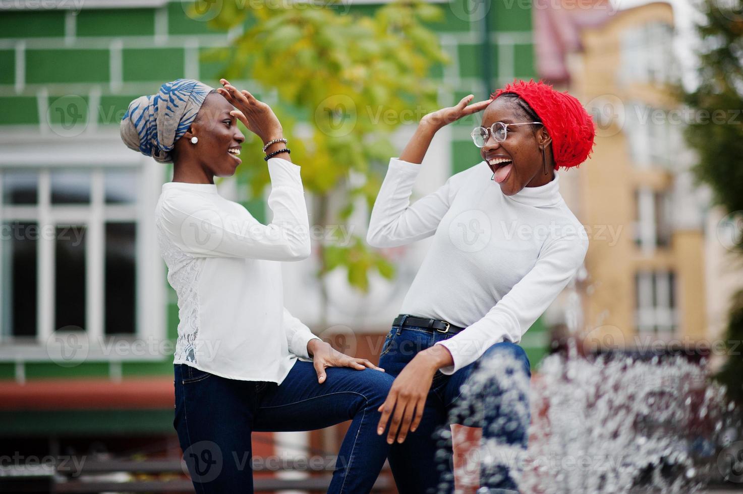 Two young modern fashionable, attractive, tall and slim african muslim womans in hijab or turban head scarf posed together. photo