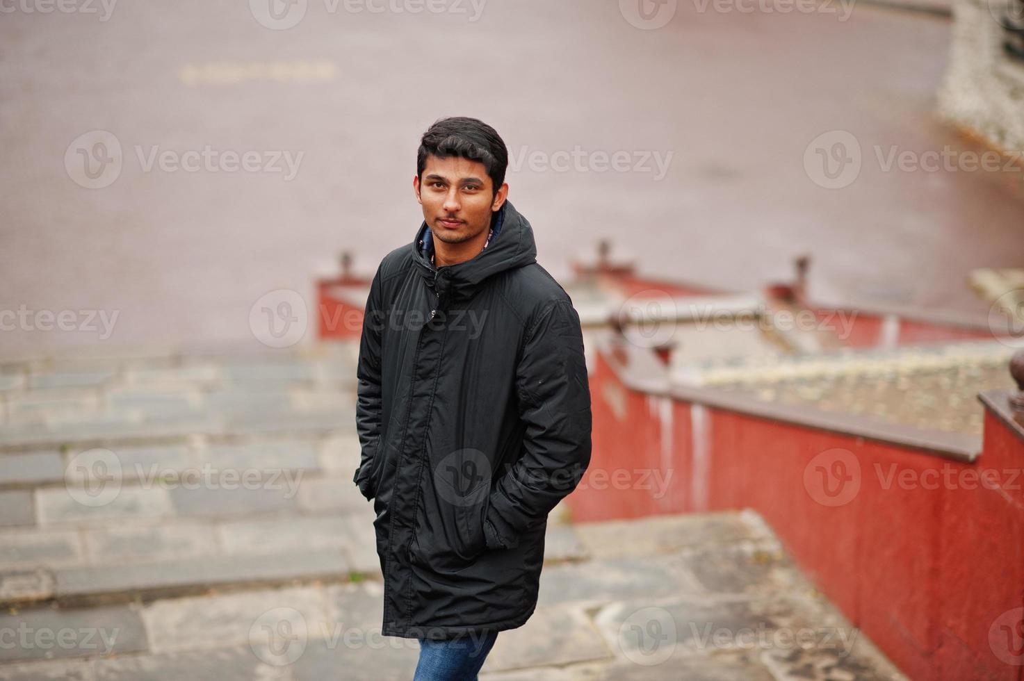 Indian man at black  jacket posed outdoor. photo