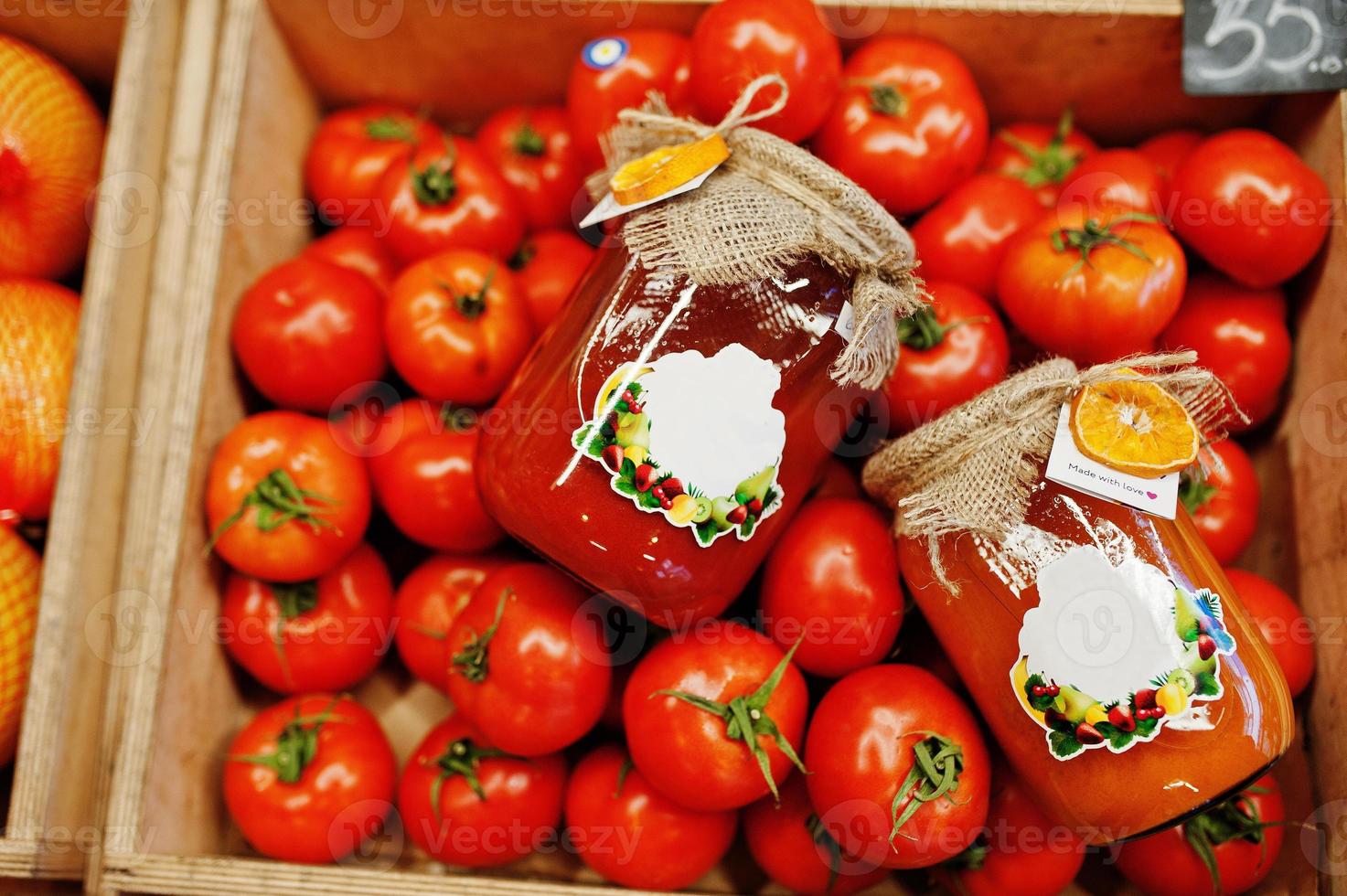 Colorful shiny fresh vegetables. Tomatoes with canning hommemade and handmade tomato juice on the shelf of a supermarket or grocery store. Made with love. photo