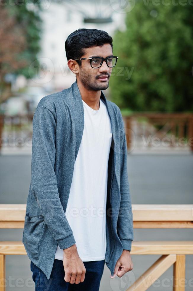 Stylish indian man at glasses wear casual posed outdoor. photo