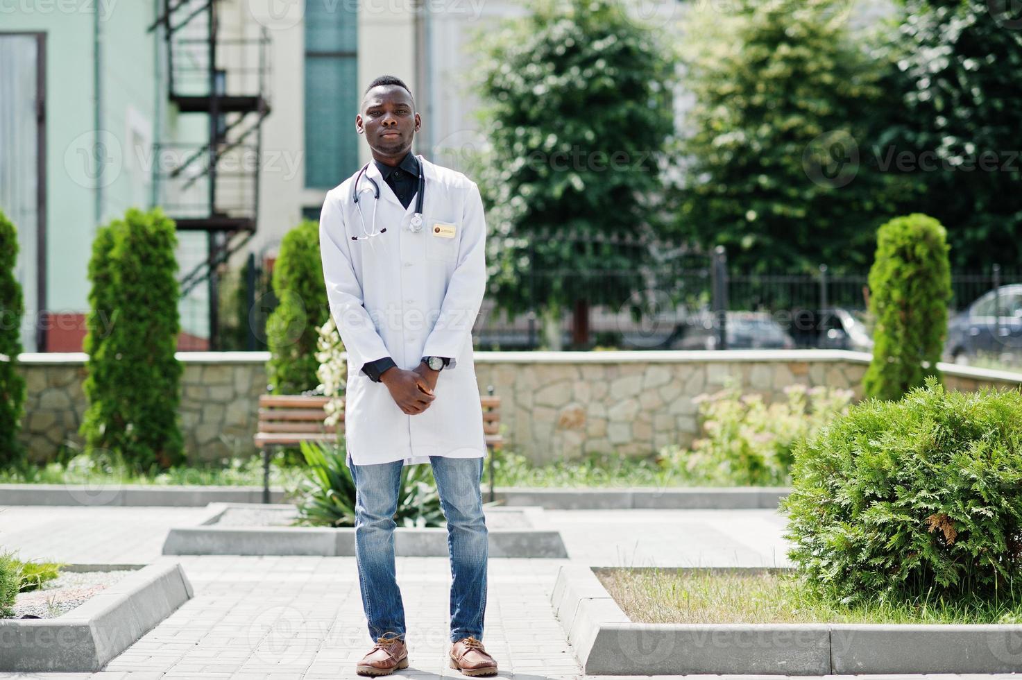 African american doctor male at lab coat with stethoscope outdoor. photo