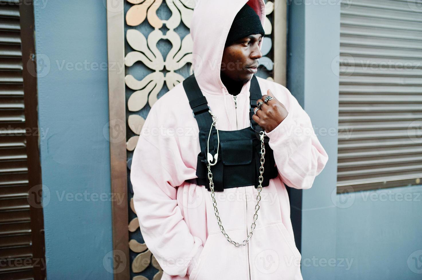 Stylish urban style african american man in pink hoodie posed. Afro rapper guy. photo