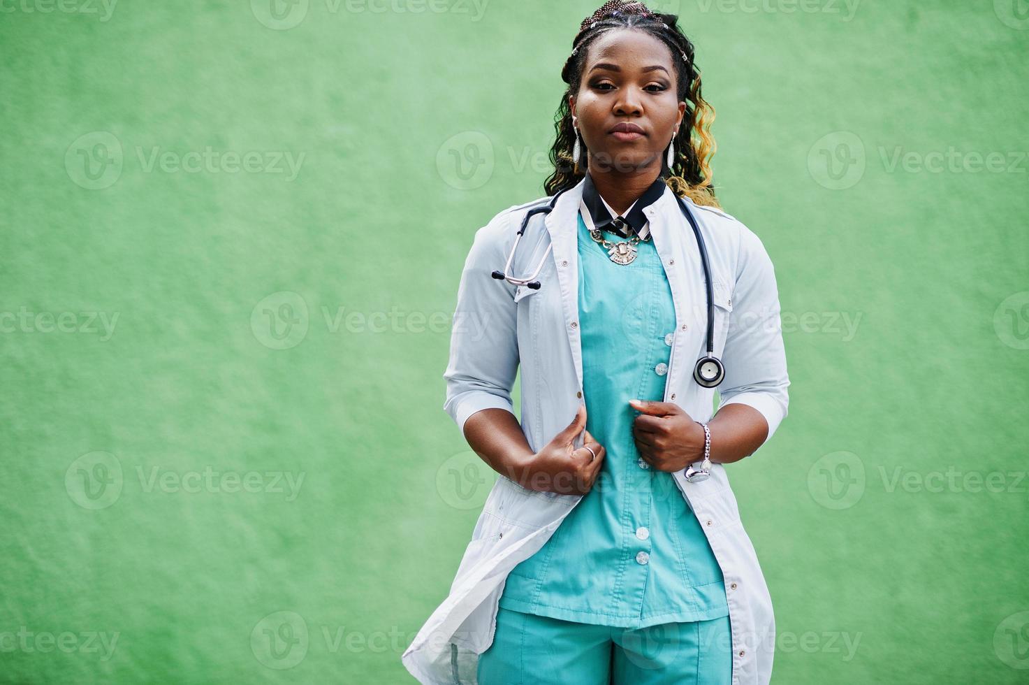 Portrait of African American female doctor with stethoscope wearing lab coat. photo